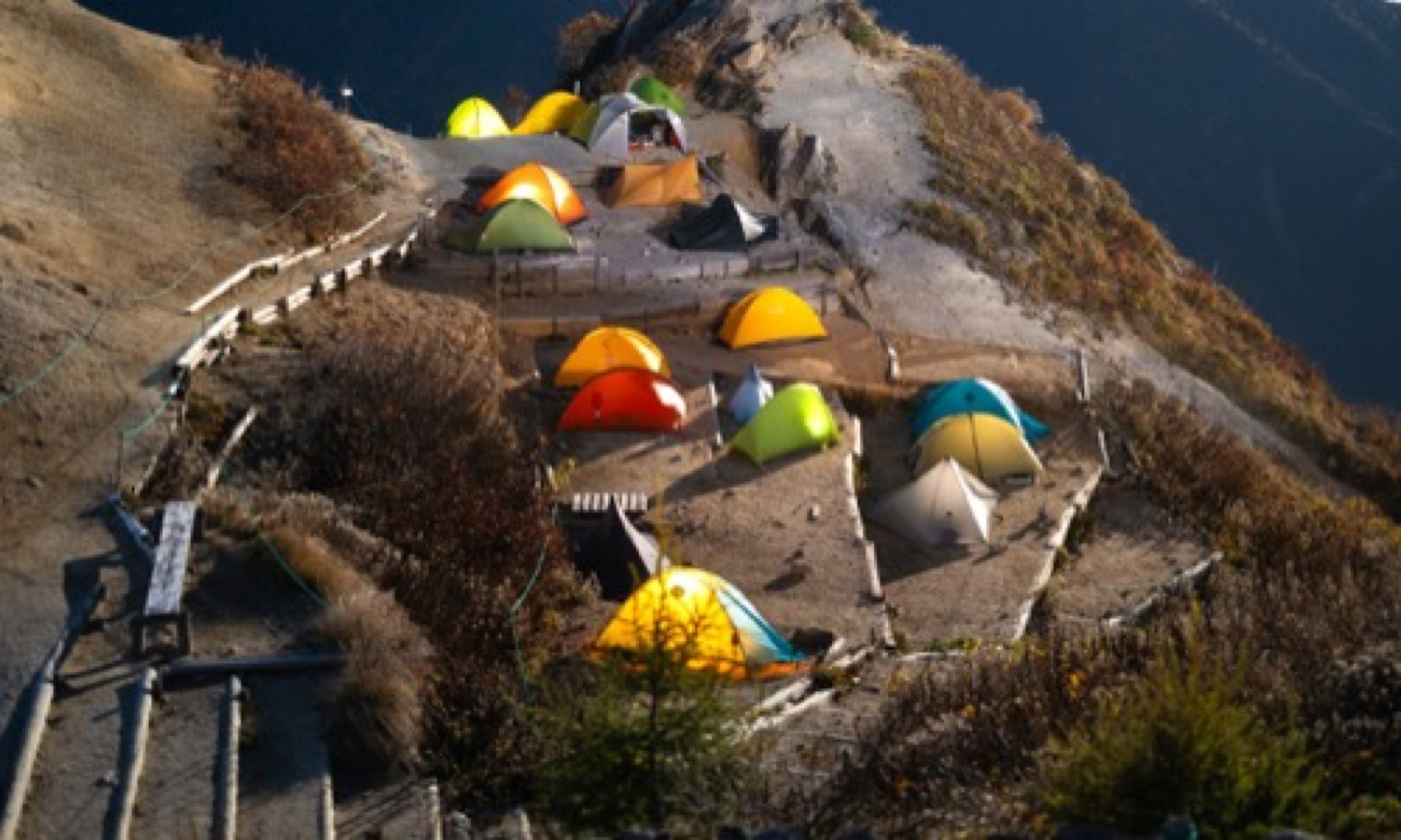 A mountain camp set along a dramatic ridge
